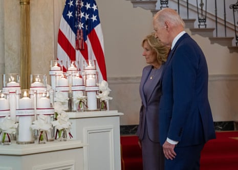 Joe Biden and first lady Jill Biden stand in front of memorial candles for the victims of the shootings at Robb Elementary School in Uvalde, Texas, in 2022.