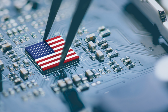 Flag of USA on a processor, CPU Central processing Unit or GPU microchip on a motherboard. [SHUTTERSTOCK]