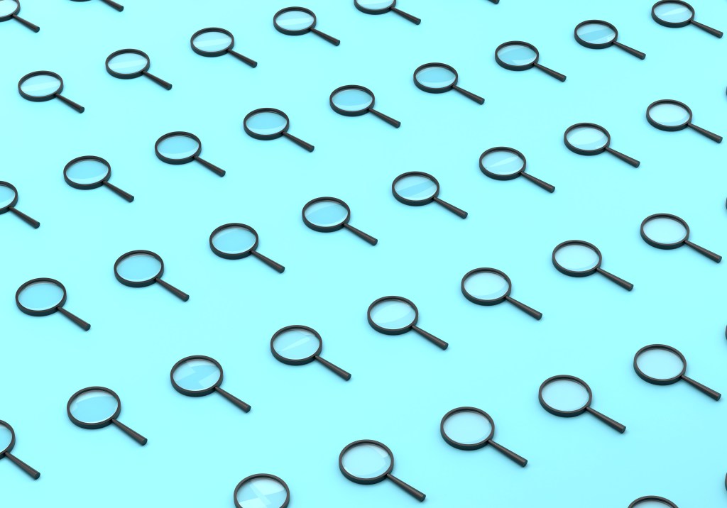 Repeated Magnifying Glass On Blue Background
