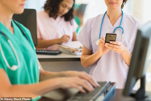 AI robots could soon be taking some of the burden off exhausted nurses by dealing with patients' questions and performing simple tasks (Stock Image)