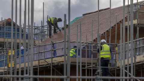Scaffolding surrounds a house under construction